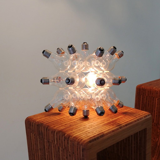 "spare" table lamp made up of 26 light bulbs