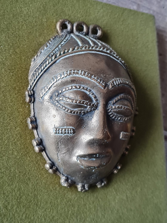 Image 1 of 2x African female and male faces in bronze on wood support