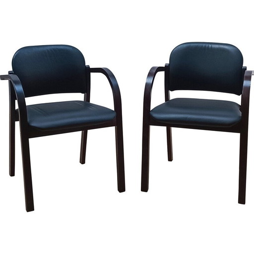 Pair of vintage chairs in black stained wood with seating and backrest upholstered in black skai