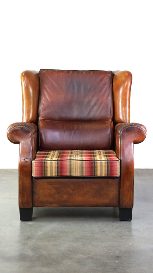 Grand fauteuil à oreilles en cuir de mouton