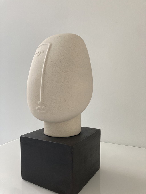 Modern Sculpture Of A Stylized Head, Made Of Rough Ceramic On Pedestal