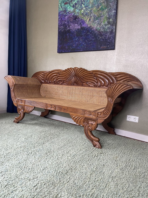 Javanese teak bench with carvings and webbing