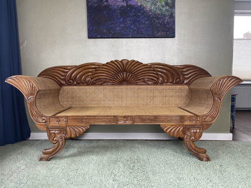 Javanese teak bench with carvings and webbing