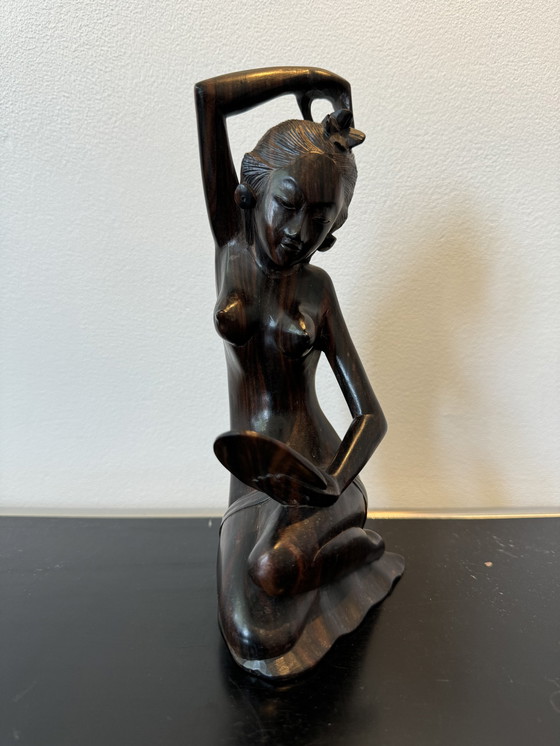 Image 1 of Sculpture en bois dans un miroir regardant une femme