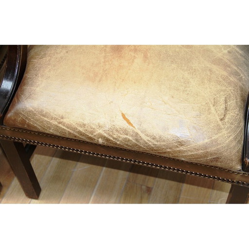 Vintage armchairs in dark wood and brown leather