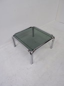 Tube frame coffee table with glass top