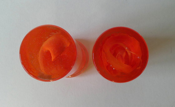 Image 1 of 2 Orange candlesticks Atoll swirl, design Anna Ehrner, Kosta Boda, Sweden