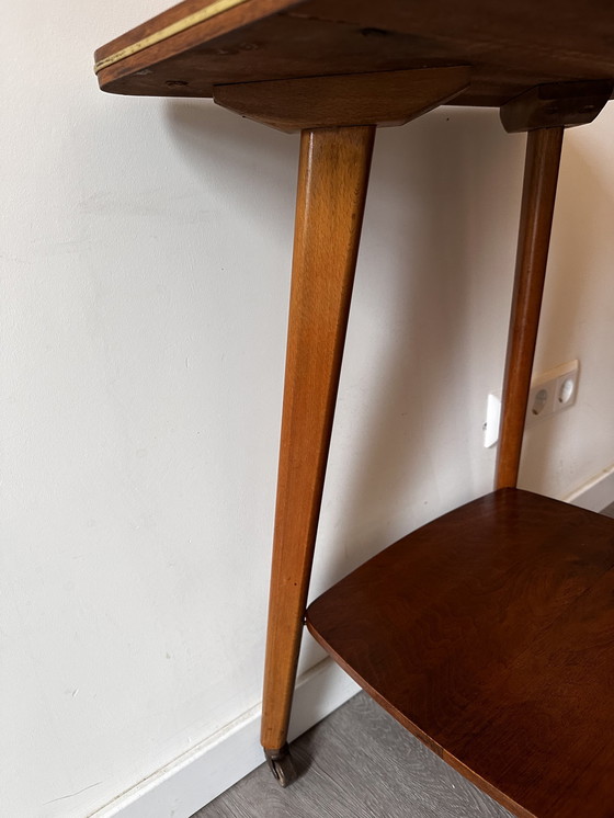 Image 1 of Side table with brass on wheels