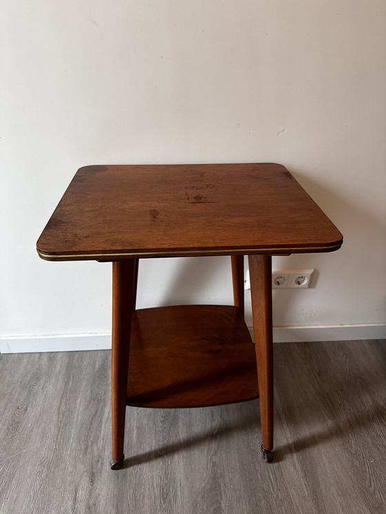 Image 1 of Side table with brass on wheels