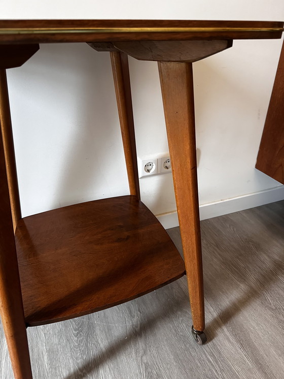 Image 1 of Side table with brass on wheels