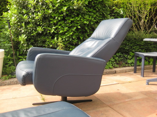 Blue leather swivel armchair with footstool