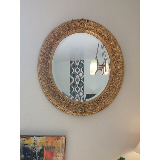 Image 1 of Vintage oval mirror with carved wood and gilded stucco decoration