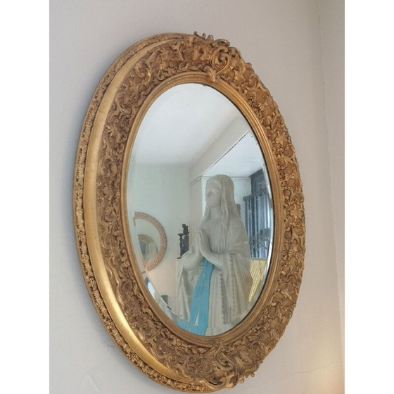 Image 1 of Vintage oval mirror with carved wood and gilded stucco decoration