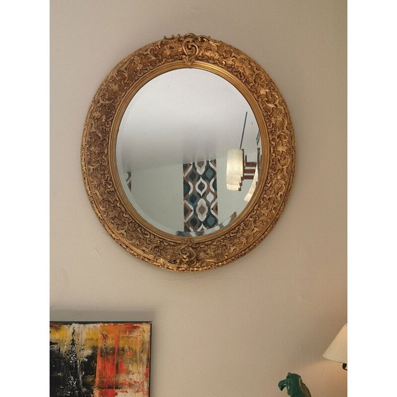 Image 1 of Vintage oval mirror with carved wood and gilded stucco decoration