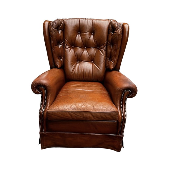 Image 1 of Comfortable armchair made of genuine leather with signs of wear