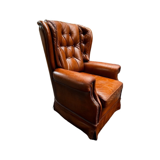 Image 1 of Comfortable armchair made of genuine leather with signs of wear