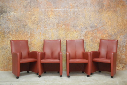 8 red leather wheeled Leolux Lapita design chairs