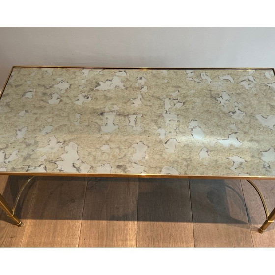 Image 1 of Neoclassical style brass coffee table with faux-antiques mirror top. French Work by Maison Jansen. Circa 1940