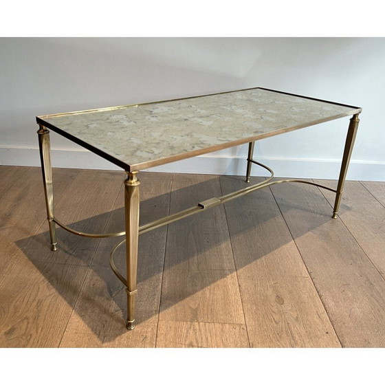 Image 1 of Neoclassical style brass coffee table with faux-antiques mirror top. French Work by Maison Jansen. Circa 1940
