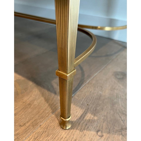 Image 1 of Neoclassical style brass coffee table with faux-antiques mirror top. French Work by Maison Jansen. Circa 1940