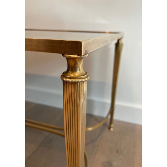 Image 1 of Neoclassical style brass coffee table with faux-antiques mirror top. French Work by Maison Jansen. Circa 1940