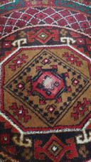Round vintage wool rug with red and yellow-brown shades 150x150cm
