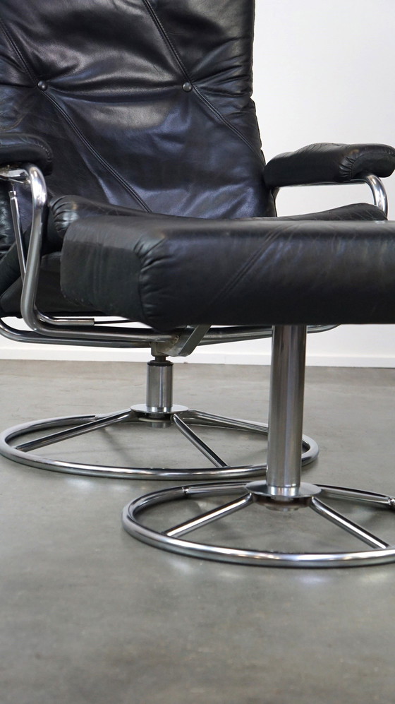 Image 1 of Black cowhide leather swivel chair + footstool