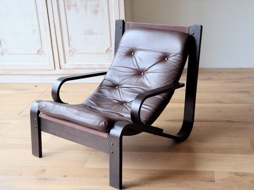 Midcentury lounge chair with a brown wooden frame