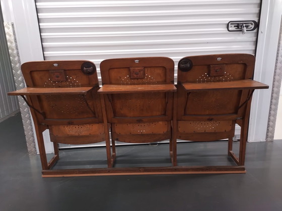 Image 1 of 3x auction chairs with folding table on the back