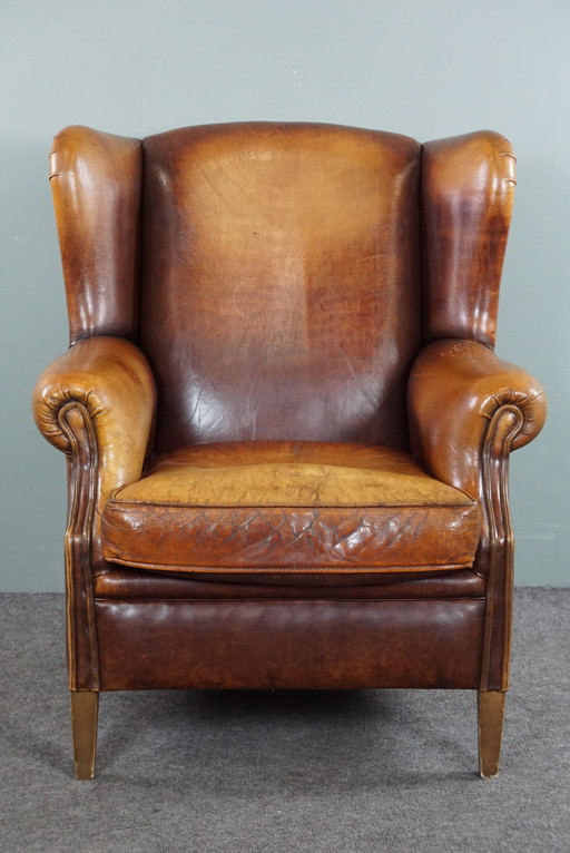 Fauteuil à oreilles en cuir de mouton marron