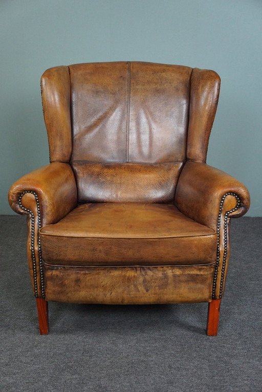 Well-fitting sheepskin leather wing chair