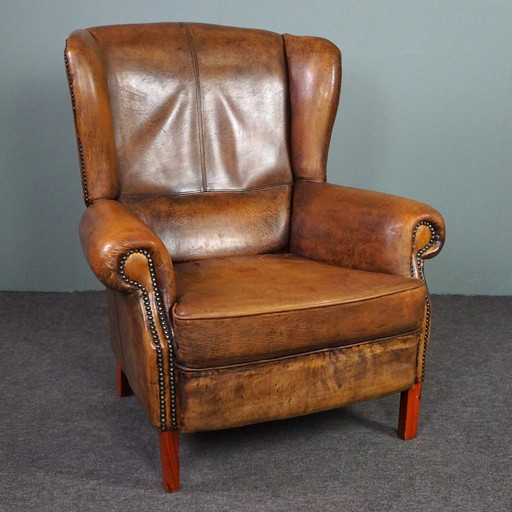 Well-fitting sheepskin leather wing chair