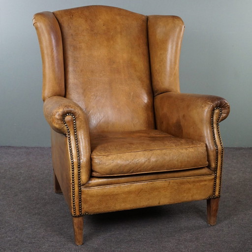 Fauteuil à oreilles en cuir de mouton clair