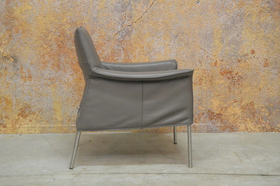 Image 1 of Gray leather Design on Stock Limec armchair