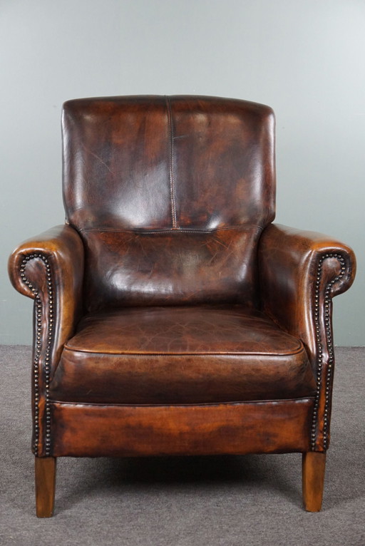 Stately sheep leather armchair, comfortable seat and high back