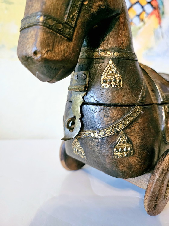 Image 1 of Vintage carved wood horse figurine with brass elements.