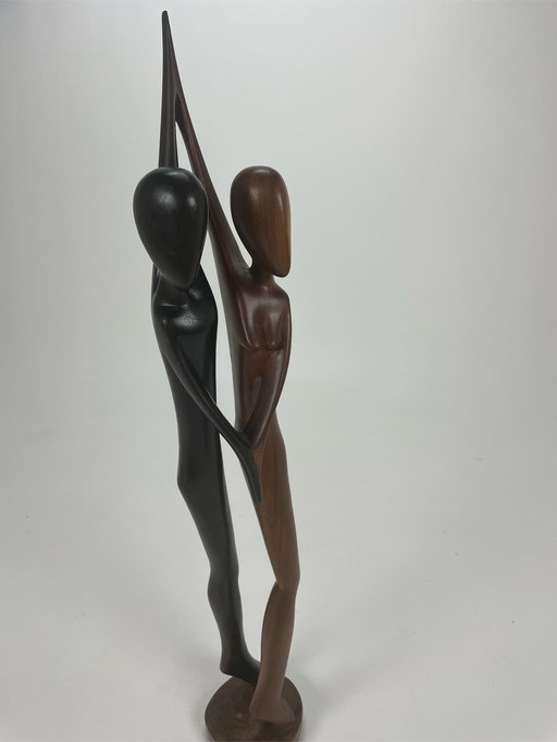 Dancing couple teak sculpture