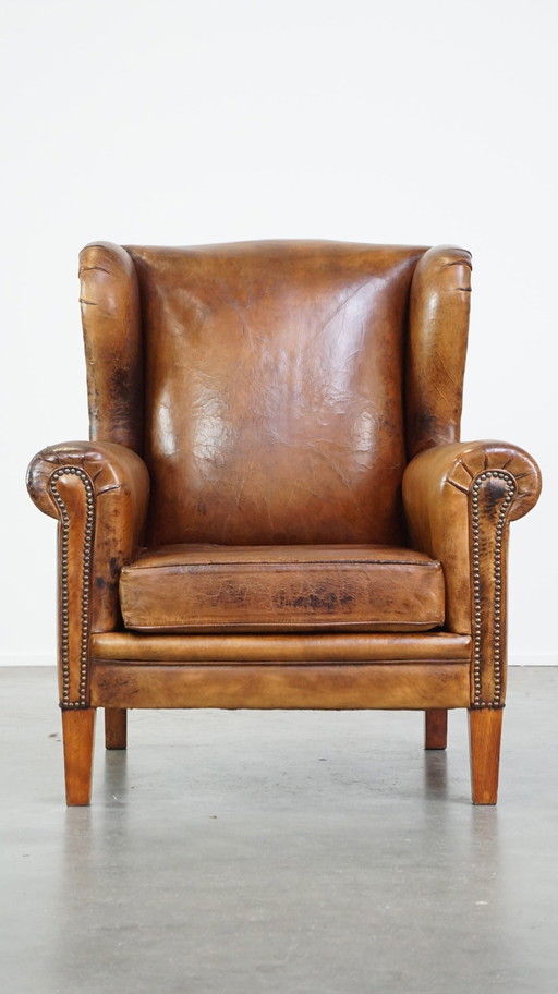 Grand fauteuil à oreilles en cuir de mouton