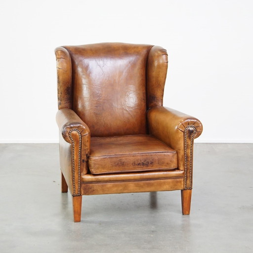 Grand fauteuil à oreilles en cuir de mouton