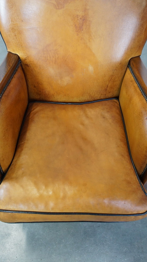 Image 1 of Fauteuil en cuir de mouton combiné avec du bois