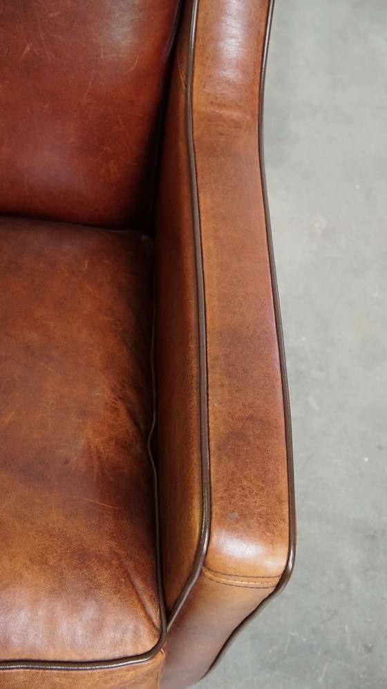 Image 1 of Fauteuil en peau de mouton avec passepoil marron foncé