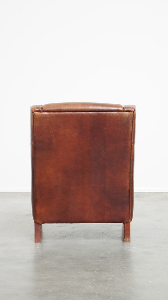 Image 1 of Fauteuil en peau de mouton avec passepoil marron foncé