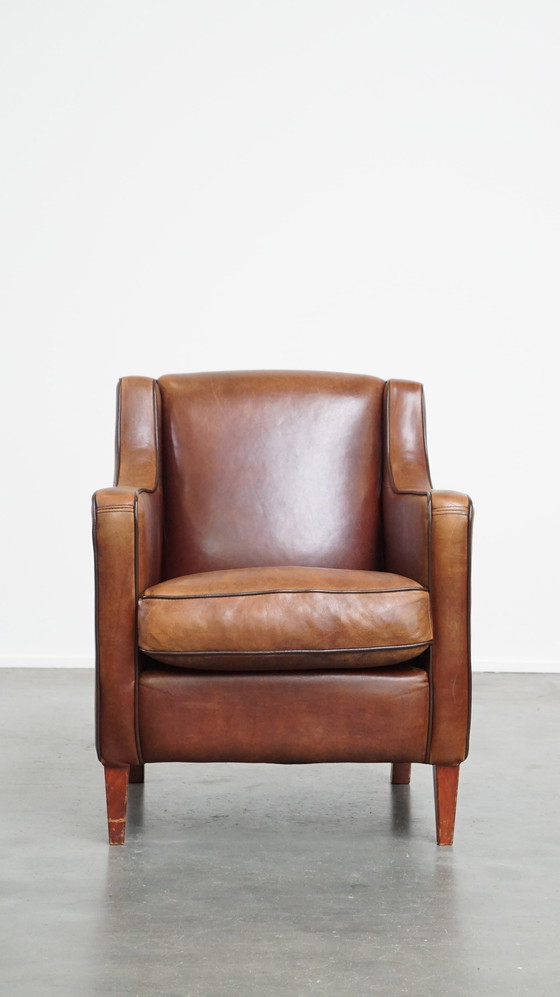 Image 1 of Fauteuil en peau de mouton avec passepoil marron foncé