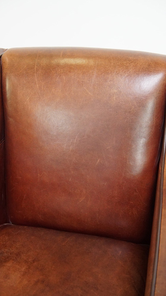 Image 1 of Fauteuil en peau de mouton avec passepoil marron foncé