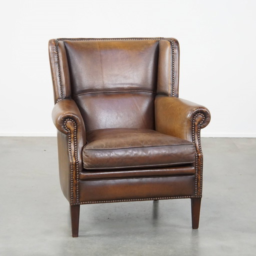 Fauteuil en cuir de mouton foncé