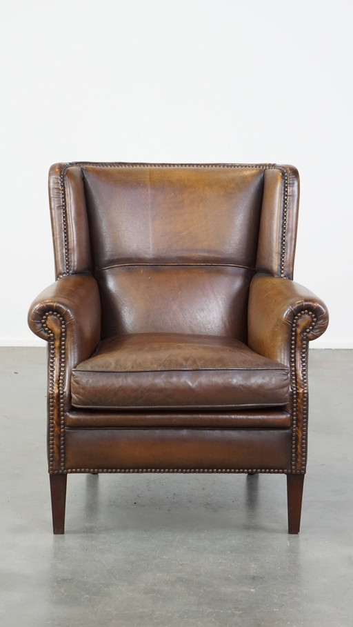 Fauteuil en cuir de mouton foncé