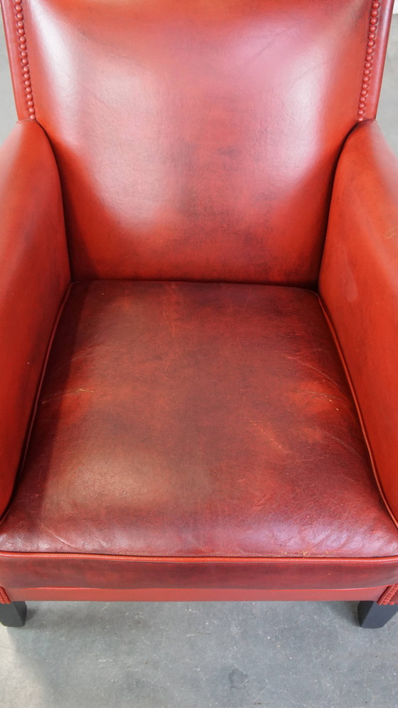 Image 1 of Fauteuil rouge en peau de mouton