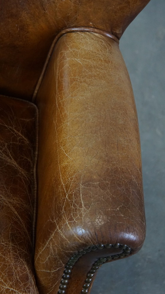 Image 1 of Fauteuil en cuir de boeuf avec pieds avant sur roulettes