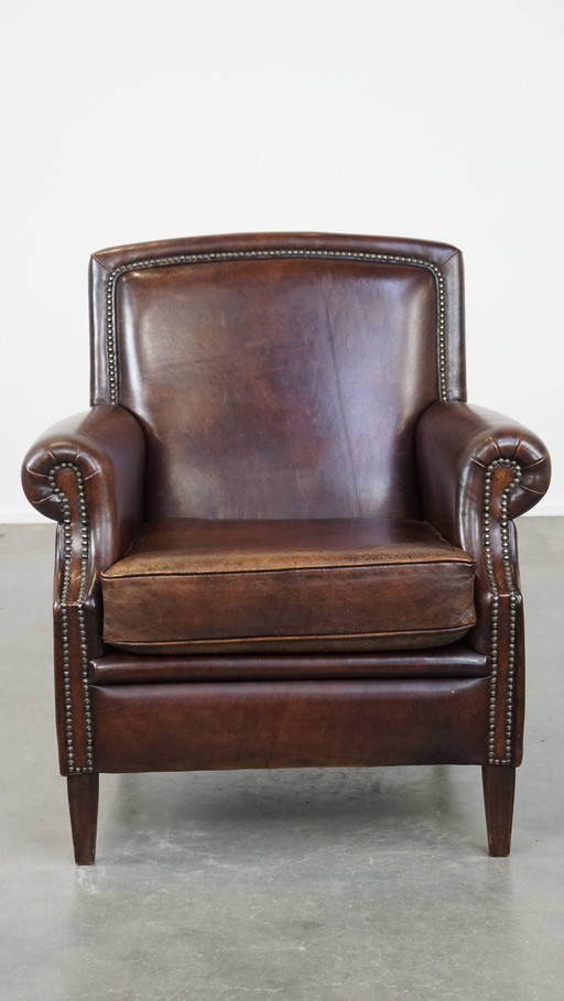 Fauteuil en cuir de mouton foncé