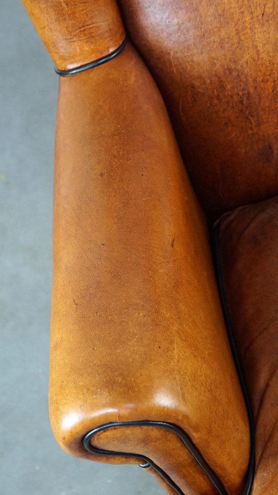 Image 1 of Fauteuil à oreilles en peau de mouton sur roues avant